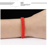 Delysia King   Red string bracelet